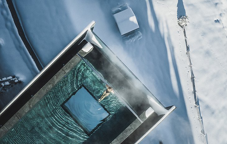 piscine en verre irréelle suspendue qui s'étend vers les montagnes  Hôtel Hubertus Italie Valdaora 